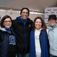 Chris with alumni smiling for picture